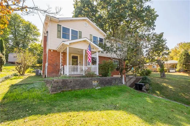 a view of a house with a backyard