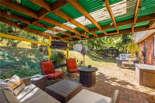 a view of a patio with table and chairs and potted plants