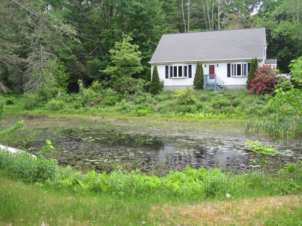 115 Baker Pond Road Dudley, MA 01571 - Photo 3 of 17 a house view with a garden space