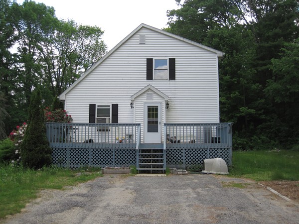 115 Baker Pond Road Dudley, MA 01571 - Photo 5 of 17 a view of a house with a balcony