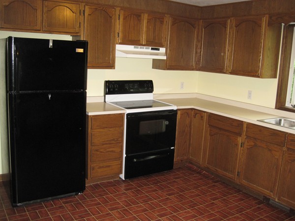115 Baker Pond Road Dudley, MA 01571 - Photo 8 of 17 a kitchen with a refrigerator and a stove
