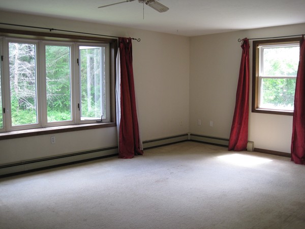 115 Baker Pond Road Dudley, MA 01571 - Photo 9 of 17 an empty room with windows