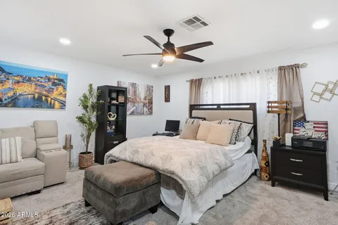 a bedroom with a bed and a couch