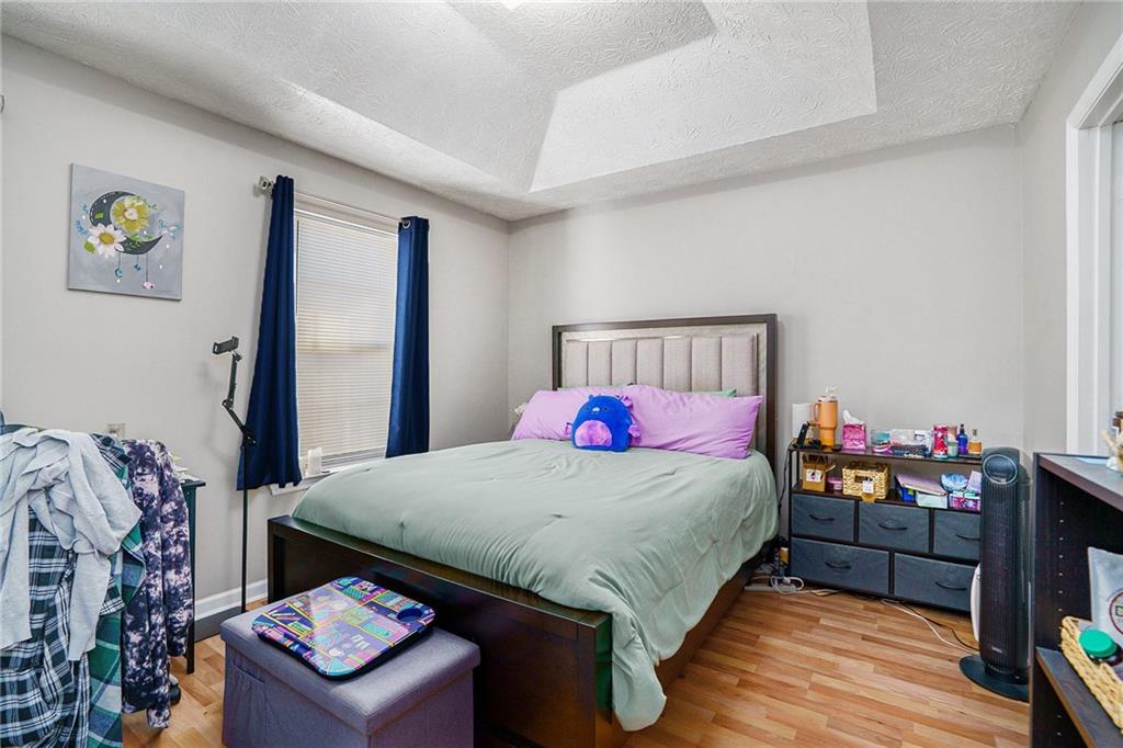 3201 Kingswood Place Decatur, GA 30034 - Photo 10 of 22 a bedroom with a bed and a dresser in it