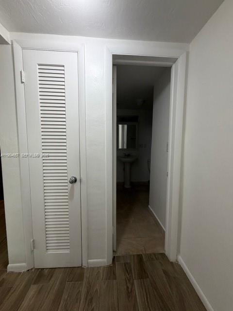 9159 Southwest 77th Avenue, Unit 409 Miami, FL 33156 - Photo 12 of 29 a view of a hallway with wooden floor and closet