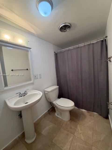 9159 Southwest 77th Avenue, Unit 409 Miami, FL 33156 - Photo 14 of 29 a bathroom with a sink toilet and a mirror