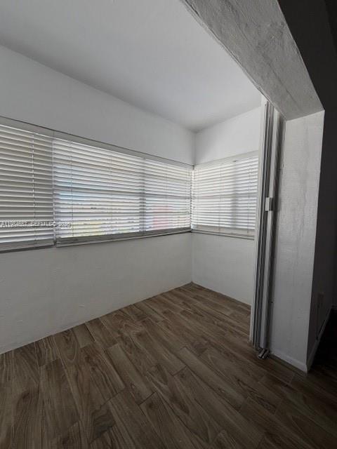 9159 Southwest 77th Avenue, Unit 409 Miami, FL 33156 - Photo 16 of 29 an empty room with wooden floor and cabinet