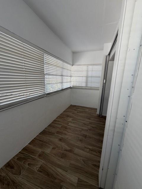 9159 Southwest 77th Avenue, Unit 409 Miami, FL 33156 - Photo 18 of 29 a view of empty room with wooden floor and fan