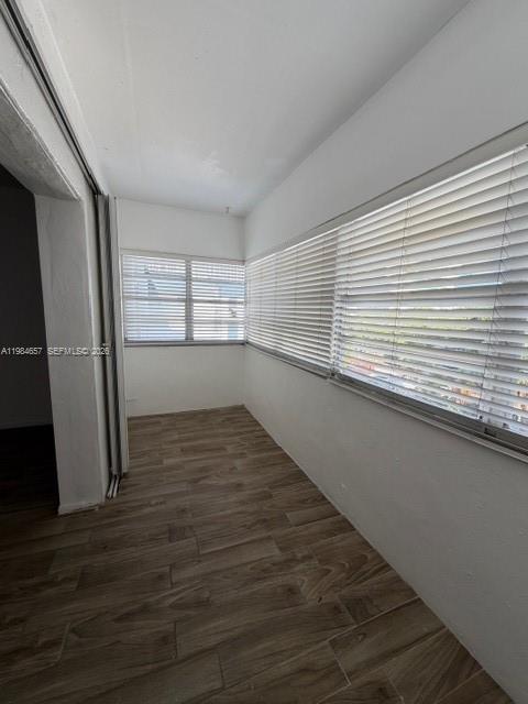 9159 Southwest 77th Avenue, Unit 409 Miami, FL 33156 - Photo 19 of 29 an empty room with wooden floor and cabinet