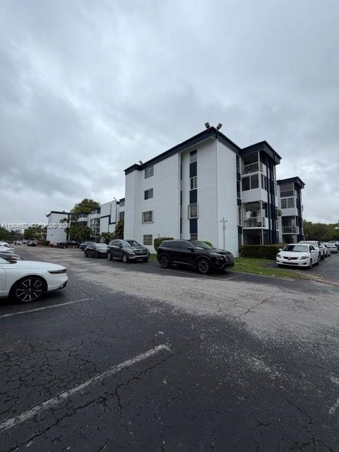 9159 Southwest 77th Avenue, Unit 409 Miami, FL 33156 - Photo 24 of 29 a car parked in front of a house