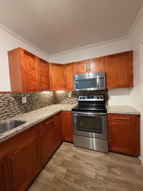 9159 Southwest 77th Avenue, Unit 409 Miami, FL 33156 - Photo 7 of 29 a kitchen with granite countertop a stove and a sink
