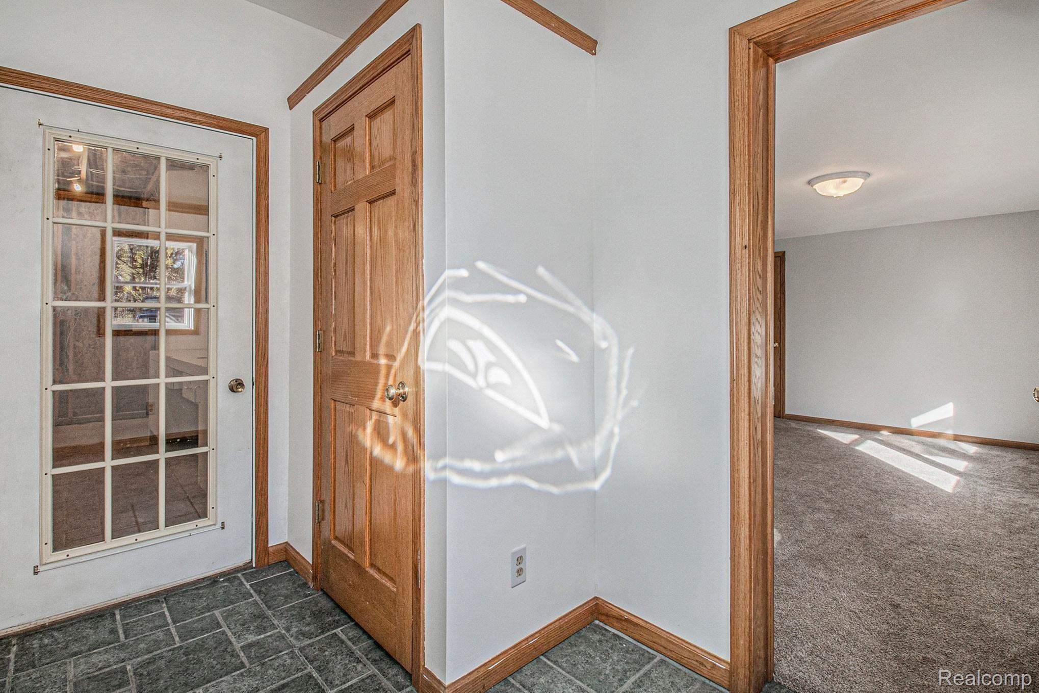 5891 Zimmer Road Williamston, MI 48895 - Photo 15 of 32 Access to Garage, Exterior and Main Floor Bedroom