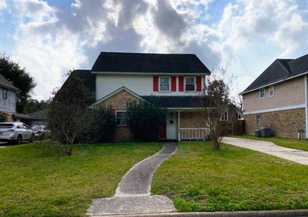 a front view of a house with a garden and yard