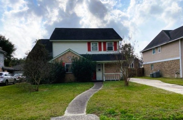 47 Devonshire Drive Conroe, TX 77304 - Photo 3 of 27 a front view of house with a garden