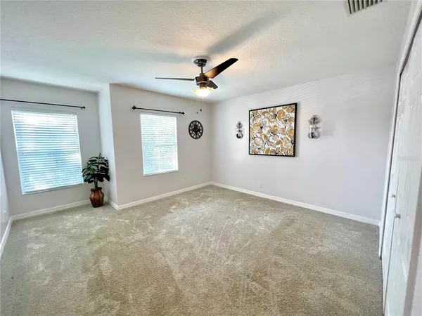 an empty room with windows and closet