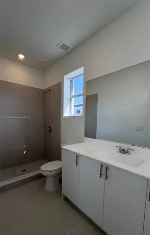 a bathroom with a sink a toilet and mirror