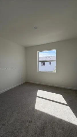 an empty room with a empty space and a window