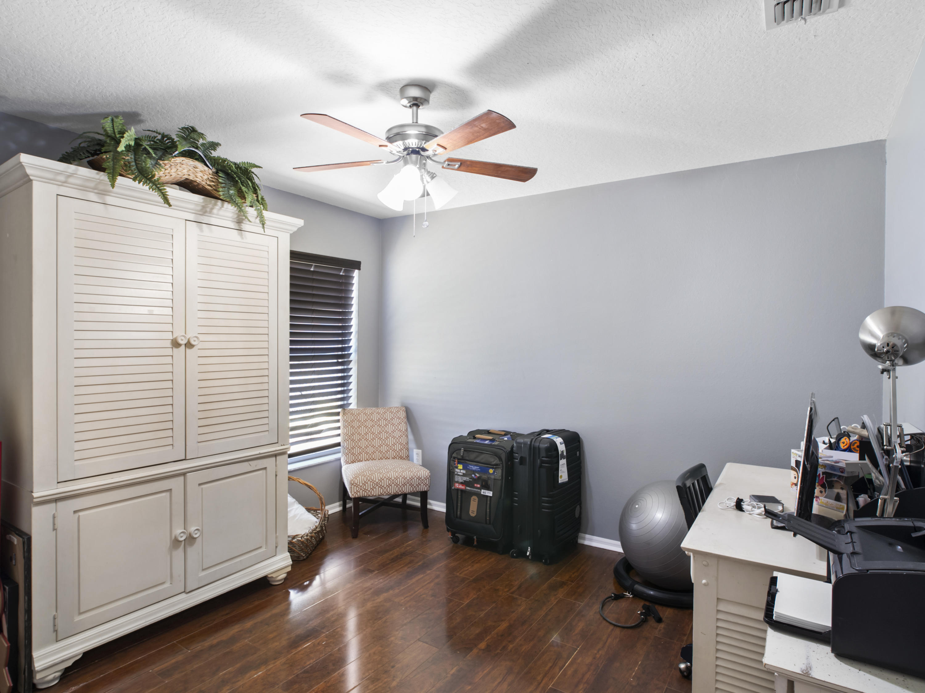 165 Southwest Covington Road Port St. Lucie, FL 34953 - Photo 13 of 26 a view of a workspace with furniture and wooden floor