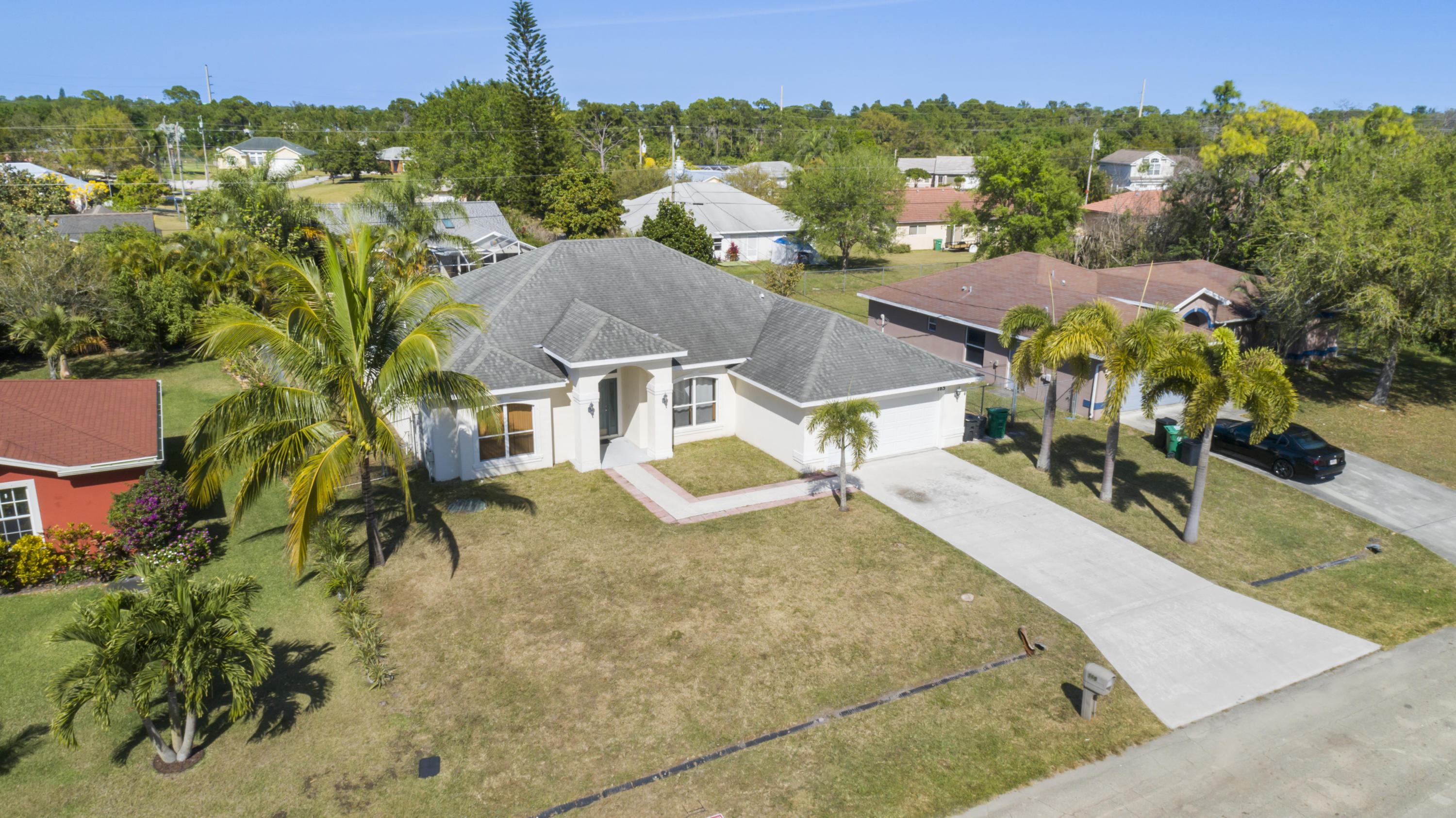 165 Southwest Covington Road Port St. Lucie, FL 34953 - Photo 2 of 26 an aerial view of residential houses with outdoor space and trees