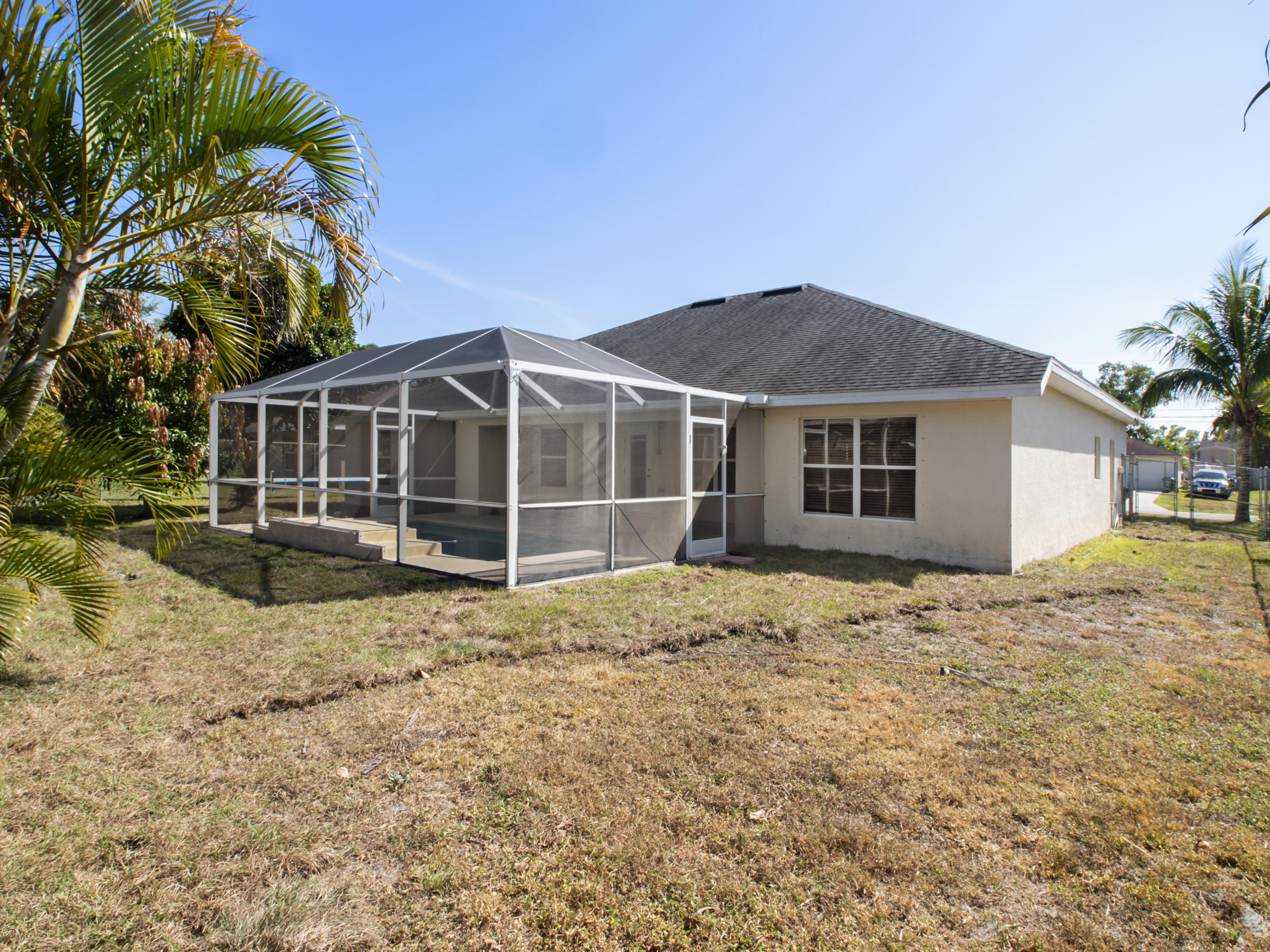 165 Southwest Covington Road Port St. Lucie, FL 34953 - Photo 26 of 26 a house with trees in the background