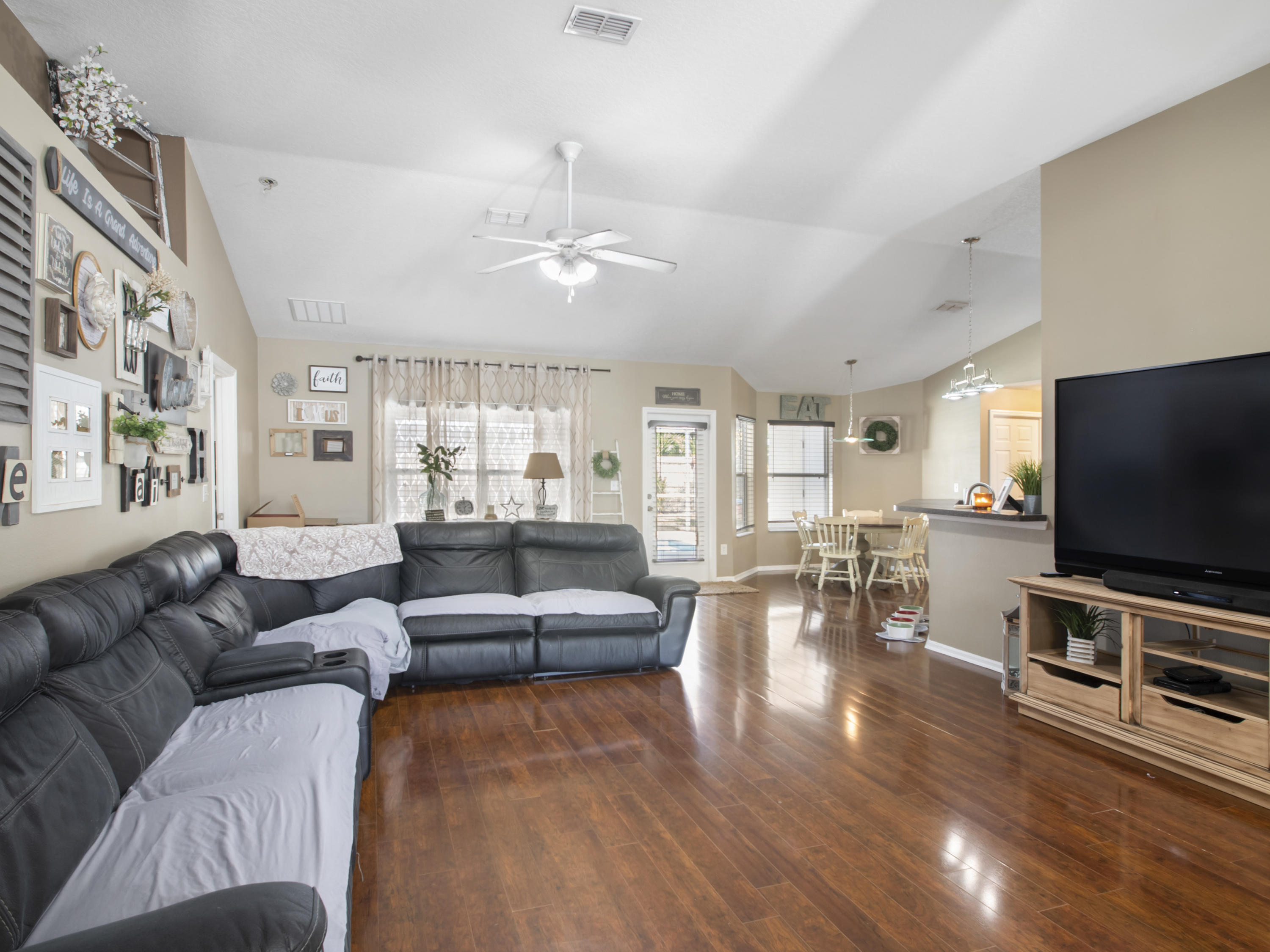 165 Southwest Covington Road Port St. Lucie, FL 34953 - Photo 5 of 26 a living room with furniture and a flat screen tv