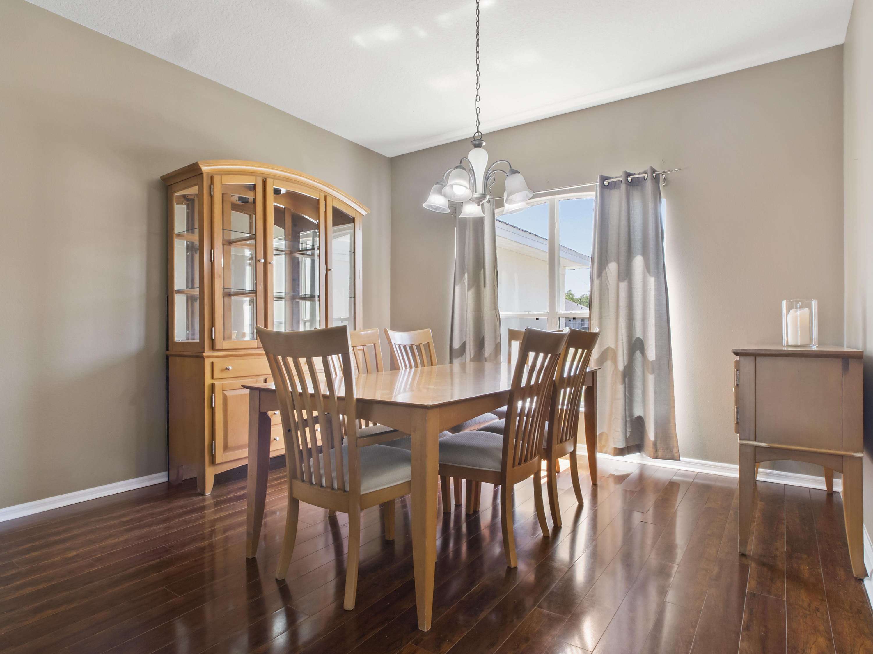 165 Southwest Covington Road Port St. Lucie, FL 34953 - Photo 6 of 26 a view of a dining room with furniture window and wooden floor