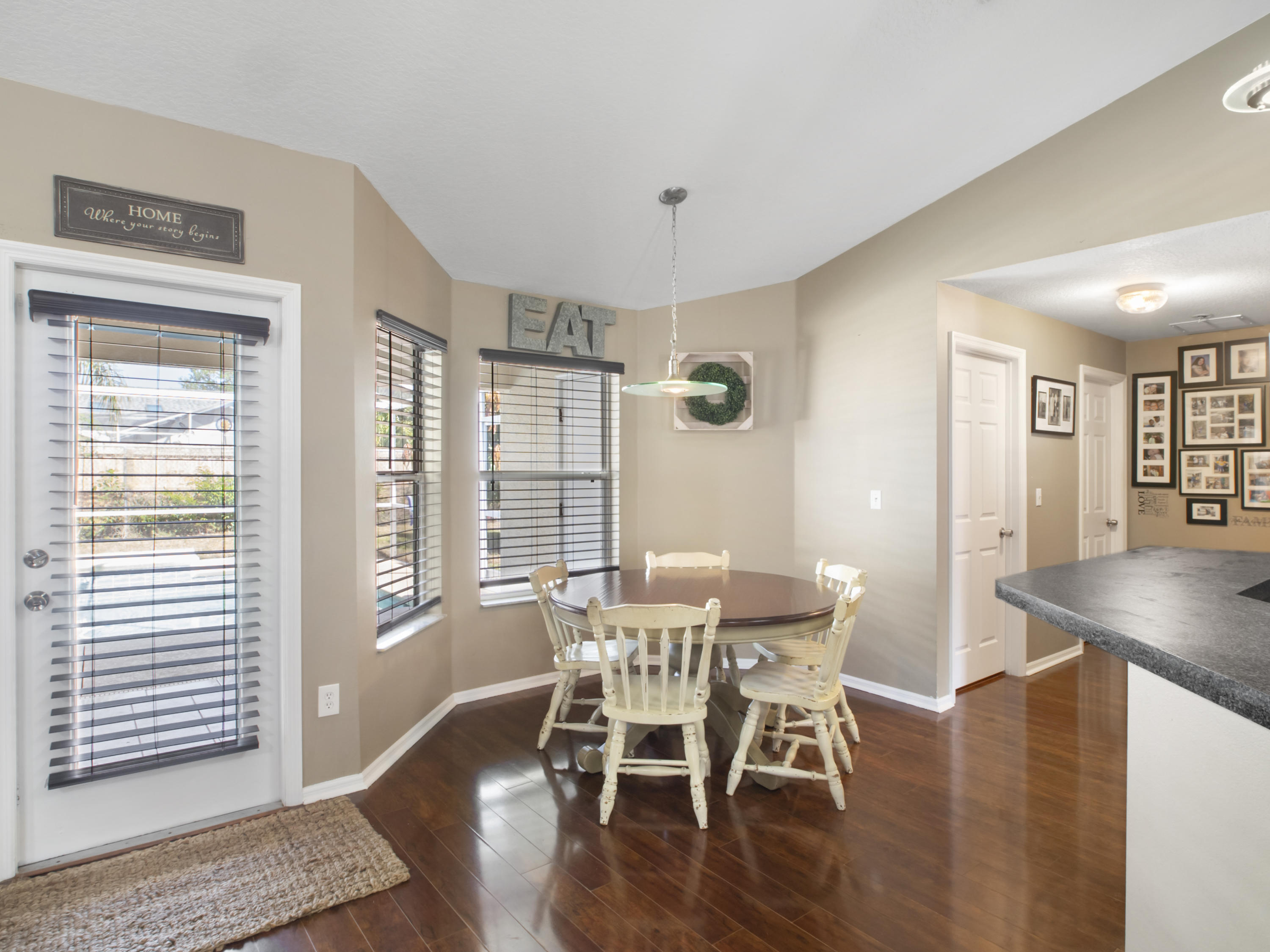 165 Southwest Covington Road Port St. Lucie, FL 34953 - Photo 7 of 26 a view of a dining room with furniture and wooden floor