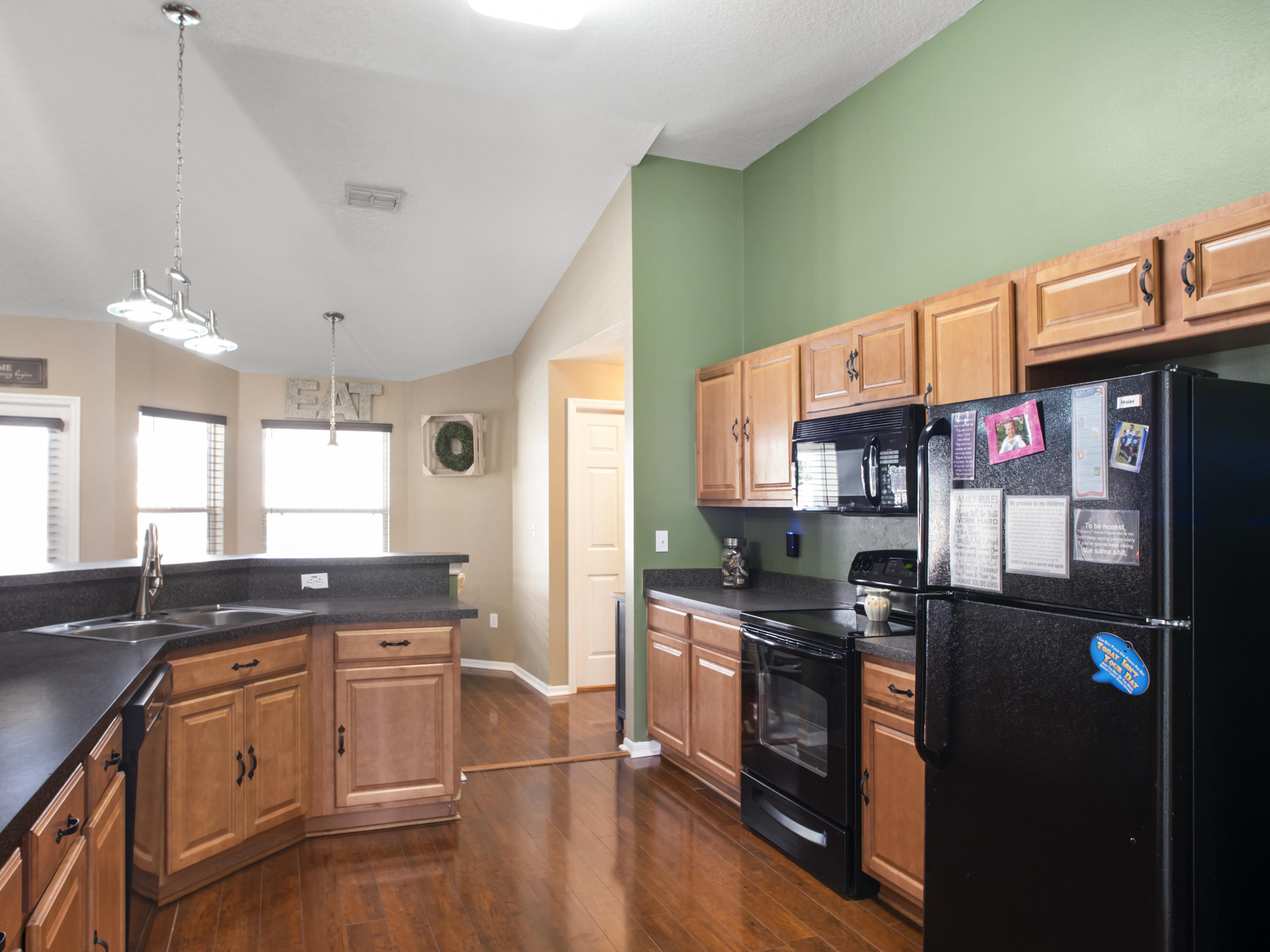 165 Southwest Covington Road Port St. Lucie, FL 34953 - Photo 9 of 26 a kitchen with stainless steel appliances granite countertop a stove a sink and a refrigerator