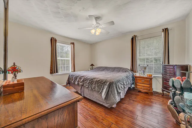 a bedroom with a bed and wooden floor