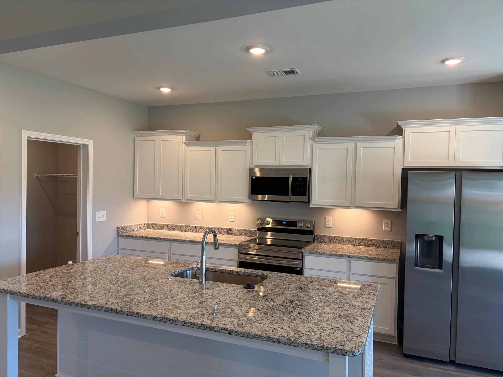 1006 Wiseman Farm Road Fairview, TN 37062 - Photo 4 of 9 a kitchen with kitchen island granite countertop a sink a counter top space appliances and cabinets