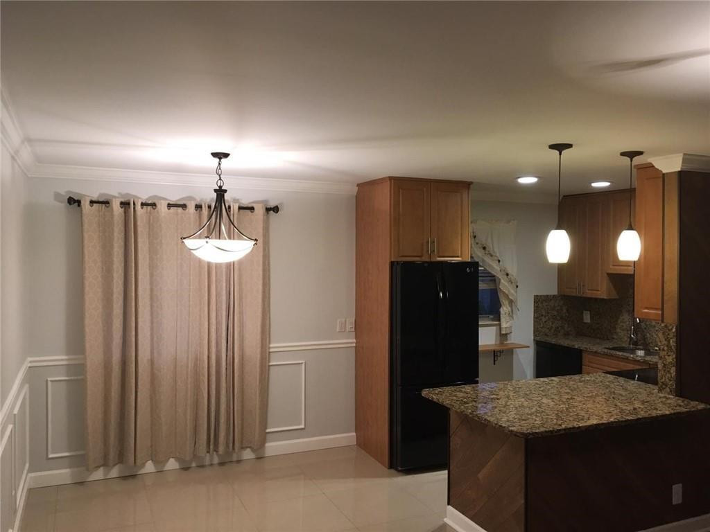 a kitchen with refrigerator and mirror