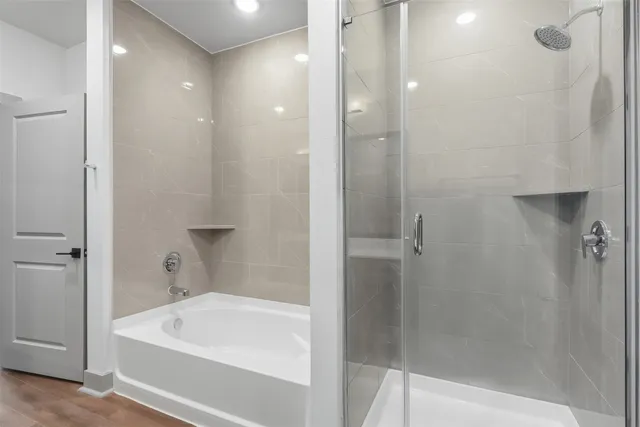 a bathroom with a bathtub and shower