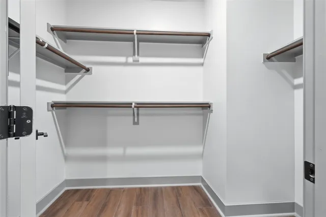 a view of walk in closet with empty racks