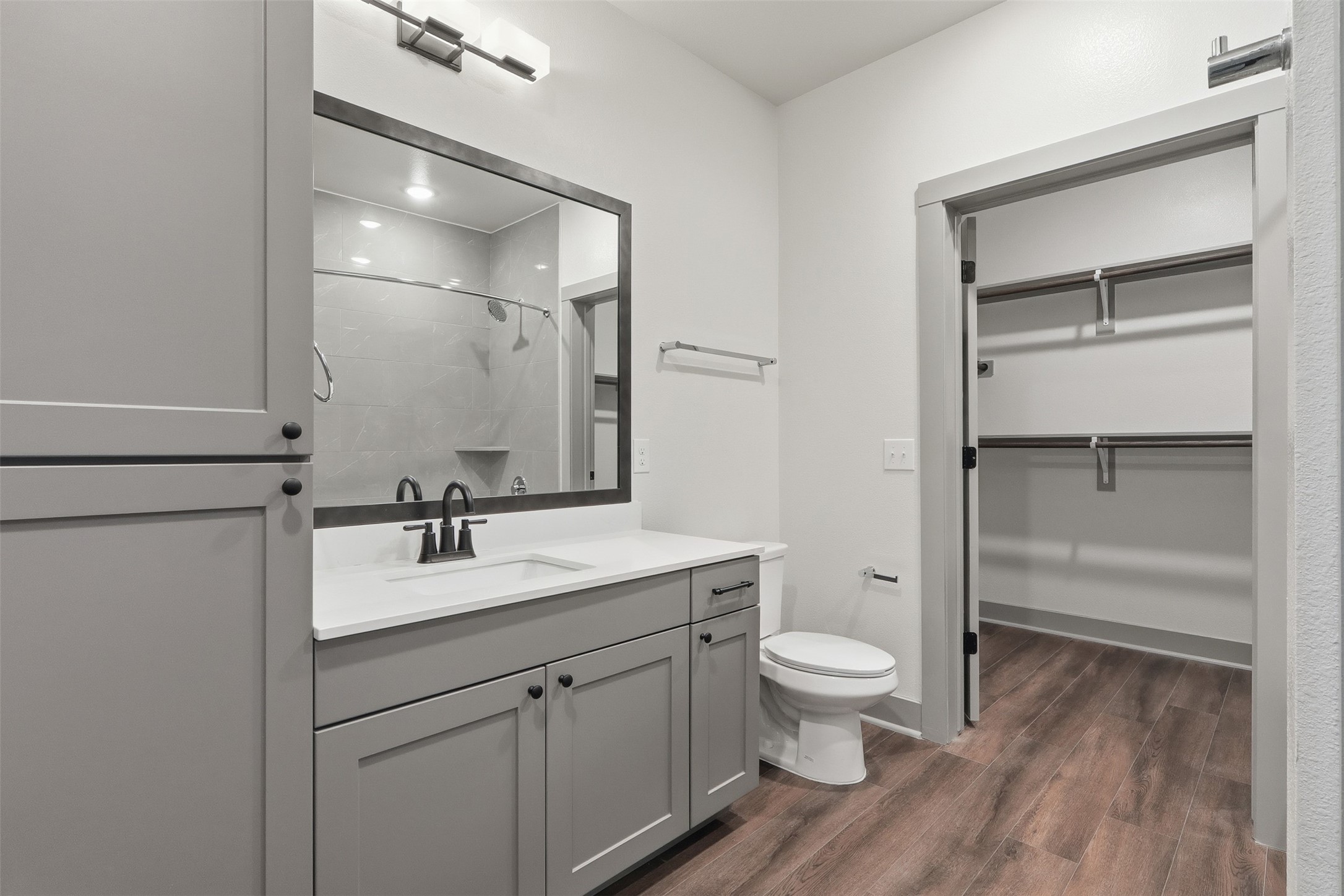1950 Winrock Boulevard, Unit B2 Houston, TX 77057 - Photo 16 of 32 a bathroom with a sink a toilet and a large mirror
