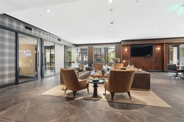 a living room with furniture and a floor to ceiling window