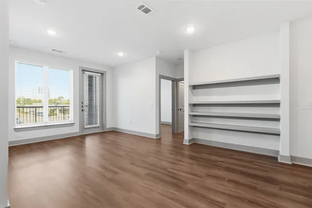 a view of room with wooden floor and window