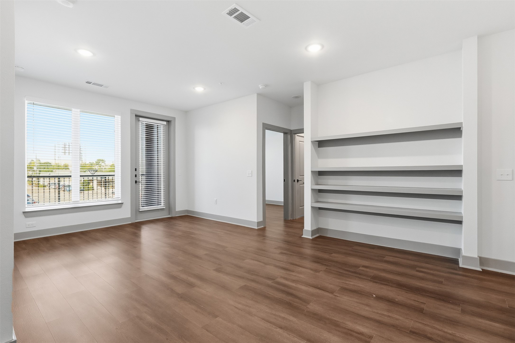 1950 Winrock Boulevard, Unit B2 Houston, TX 77057 - Photo 5 of 32 a view of room with wooden floor and window
