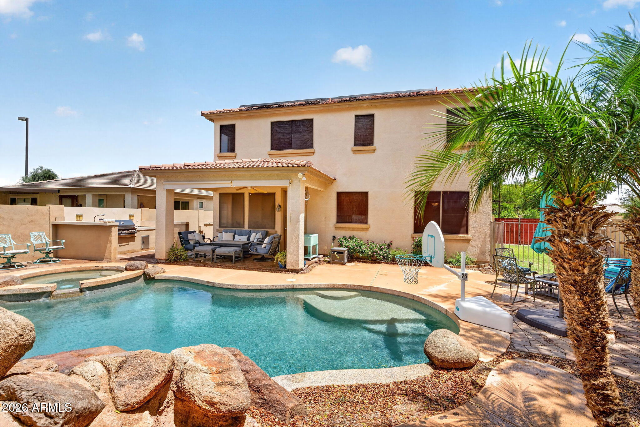 6280 South Sinova Court Gilbert, AZ 85298 - Photo 50 of 64 a front view of a house with swimming pool having outdoor seating