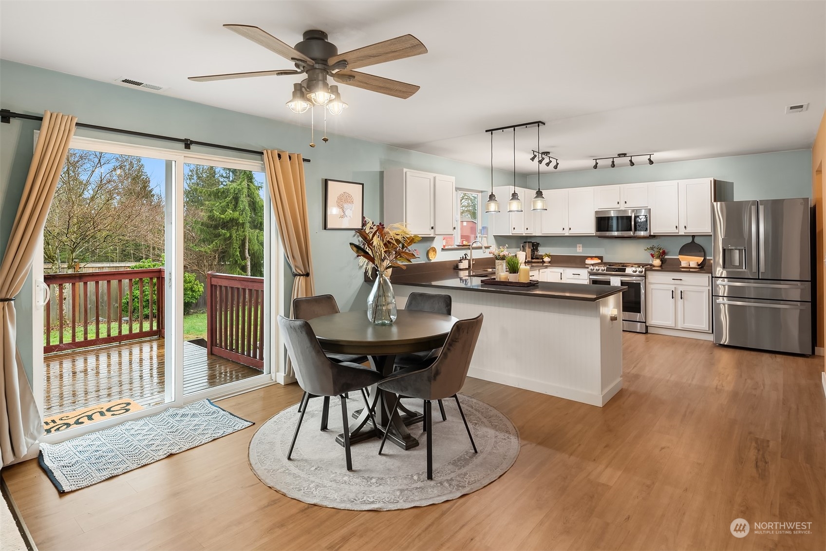 14125 Corbridge Road Southeast Monroe, WA 98272 - Photo 5 of 34 a living room with stainless steel appliances granite countertop furniture wooden floor and a kitchen view