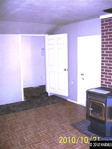 4531 Azalea Drive Reno, NV 89502 - Photo 8 of 10 a view of an empty room with a fireplace and a window