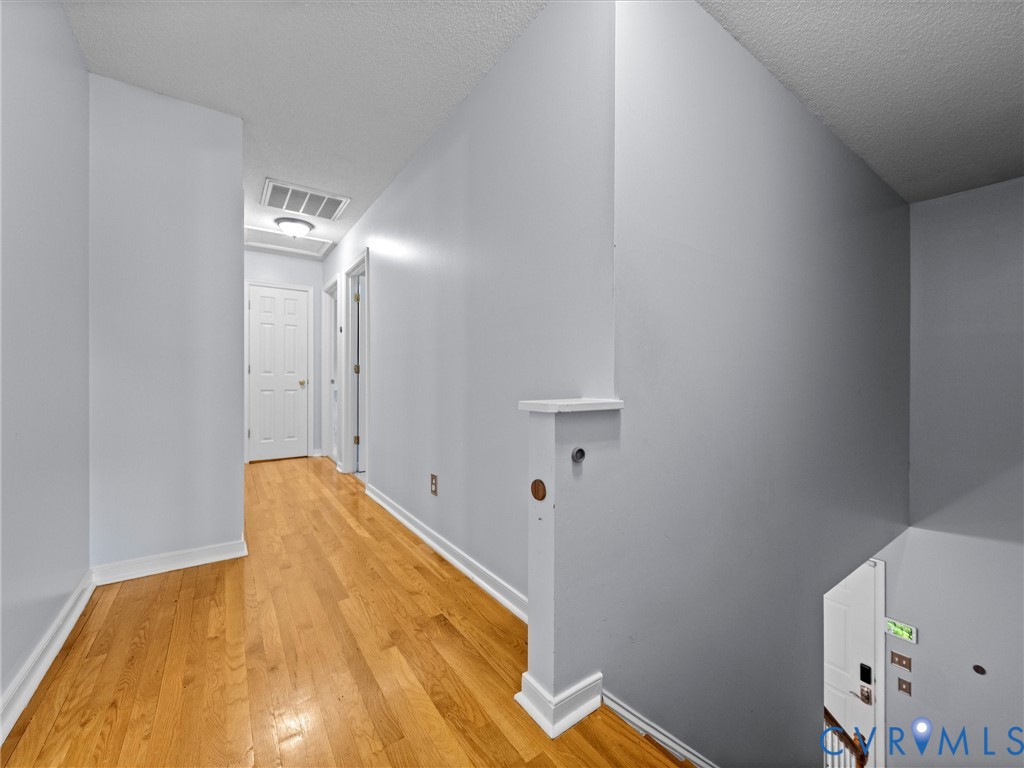 6712 Hedges Road Richmond, VA 23224 - Photo 24 of 34 Hallway featuring wood-finish flooring, light gray