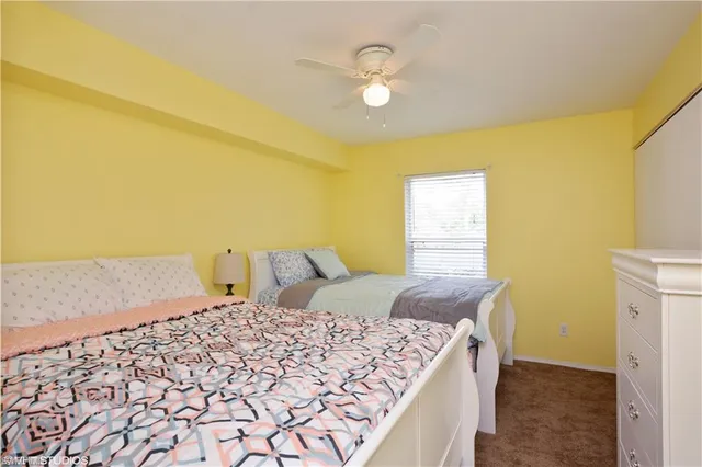 a bed sitting in a bedroom next to a window