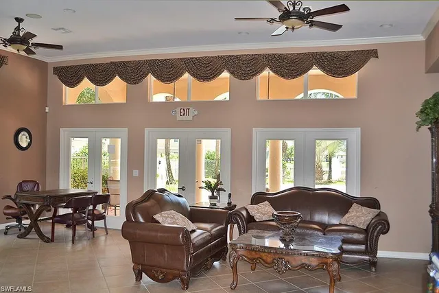 a living room with furniture flowerpot and a mirror