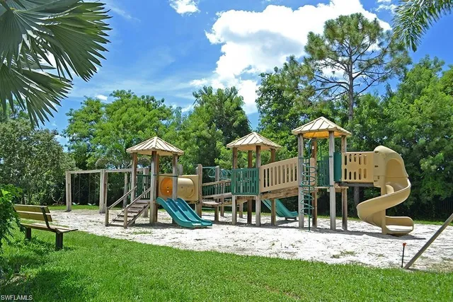 a childrens park with lots of swings and slides