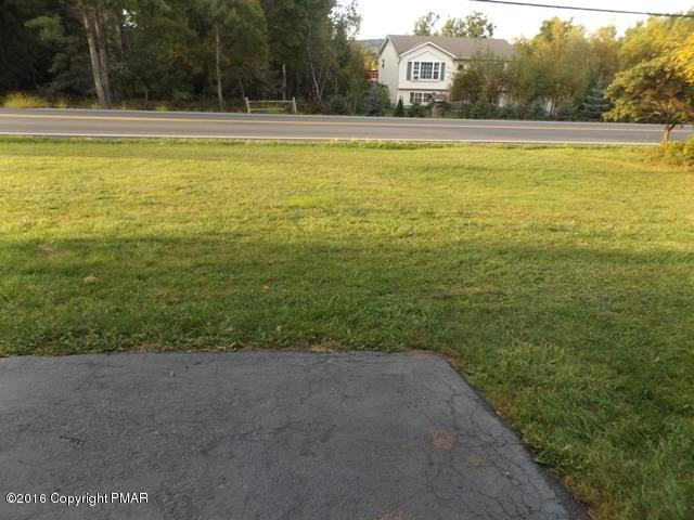 618 Mountain Road Albrightsville, PA 18210 - Photo 3 of 14 a view of a large pool with lawn chairs under an umbrella