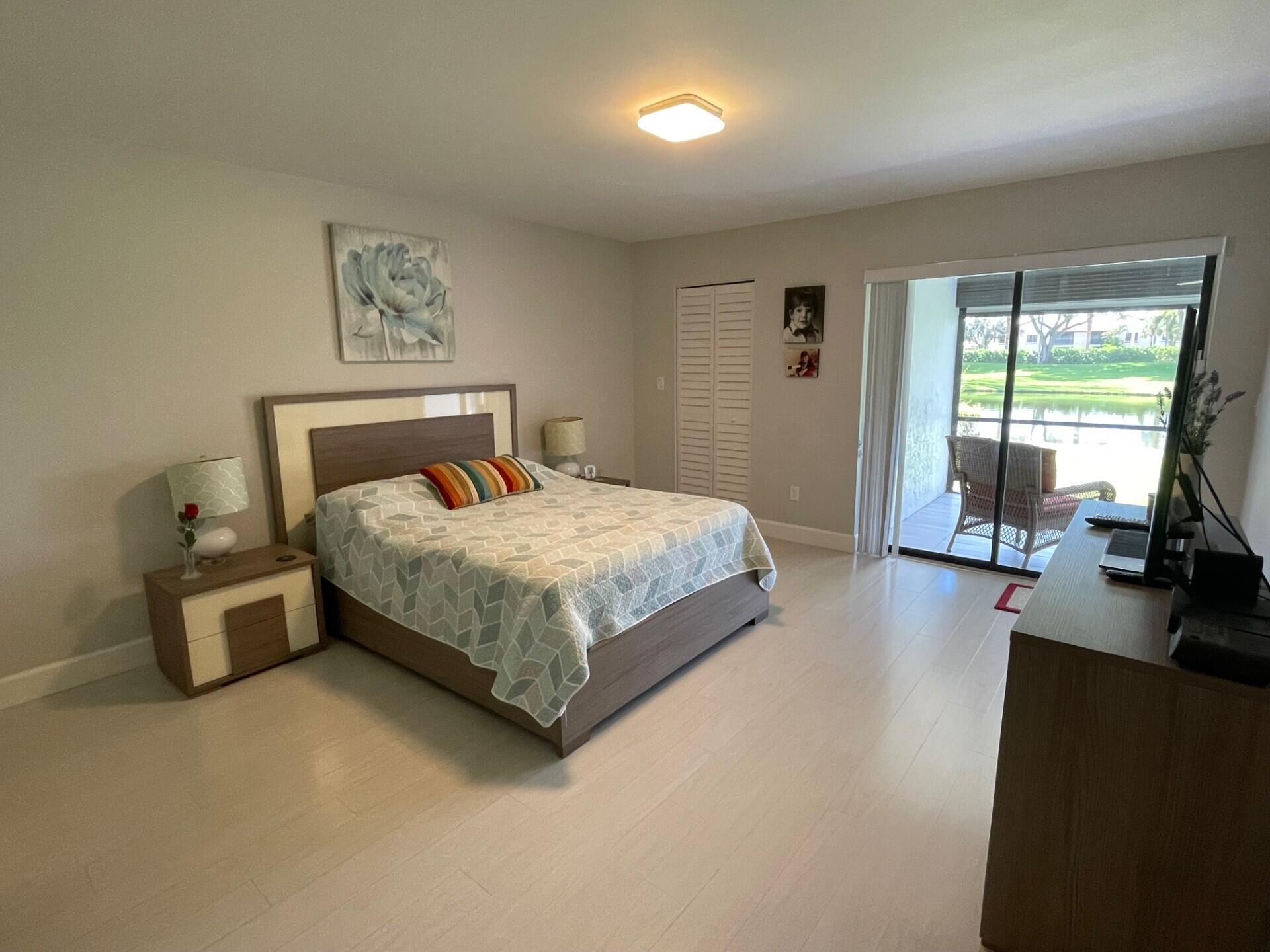 8471 Boca Glades Boulevard East Boca Raton, FL 33434 - Photo 13 of 29 a bedroom with a bed and a flat tv screen on the dresser