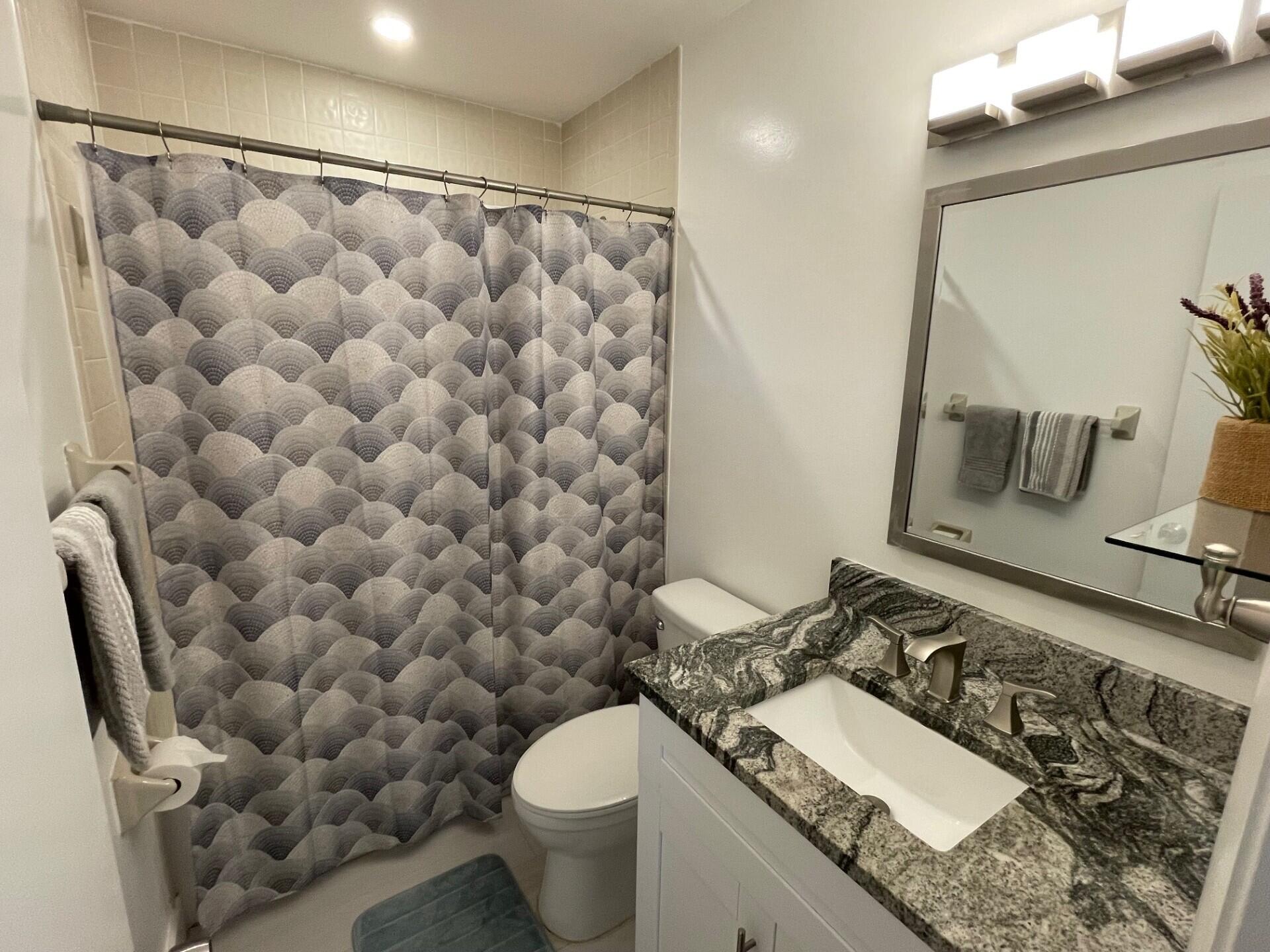 8471 Boca Glades Boulevard East Boca Raton, FL 33434 - Photo 15 of 29 a bathroom with a granite countertop sink and a mirror