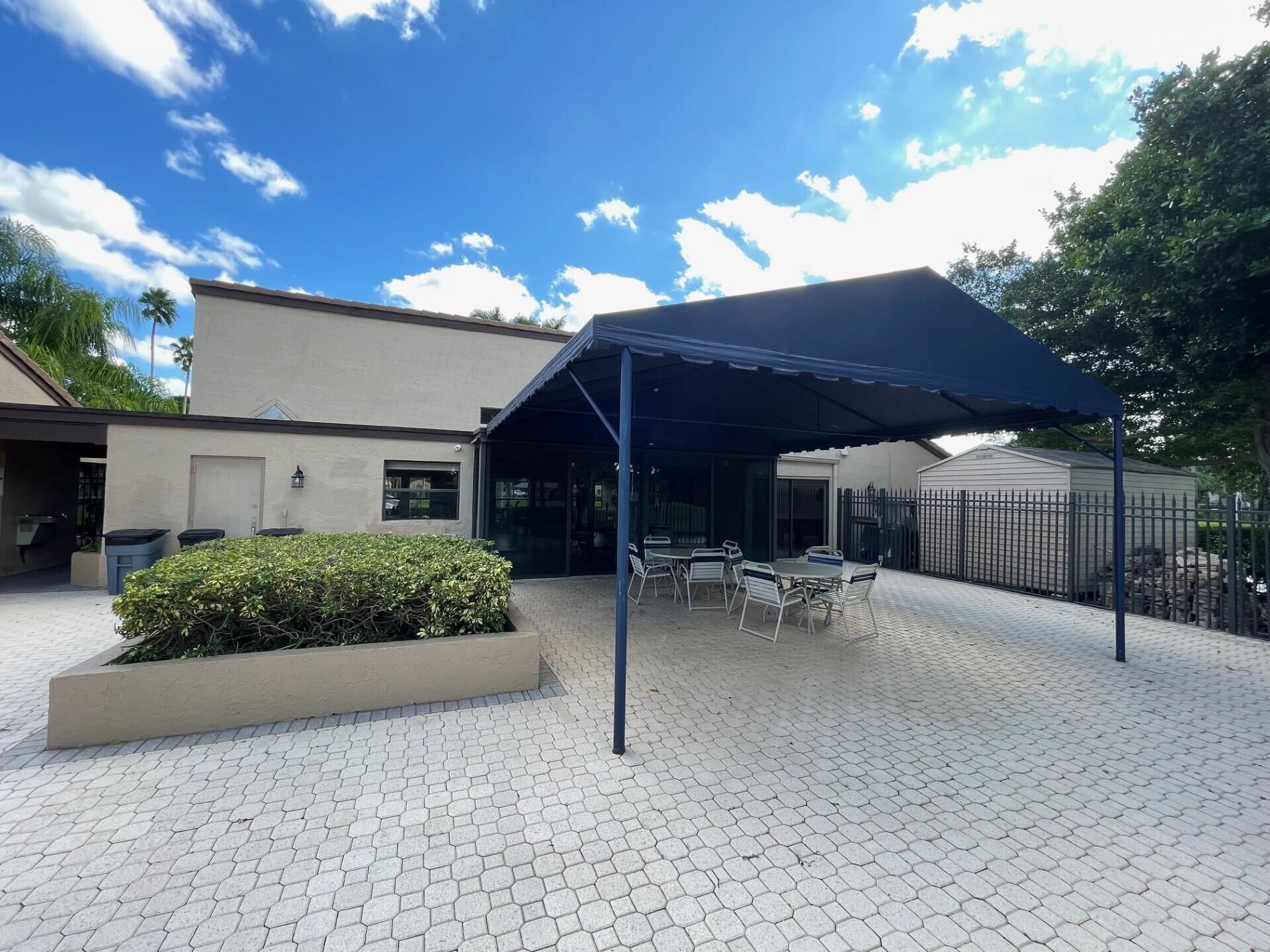 8471 Boca Glades Boulevard East Boca Raton, FL 33434 - Photo 19 of 29 a view of a house with backyard and sitting area