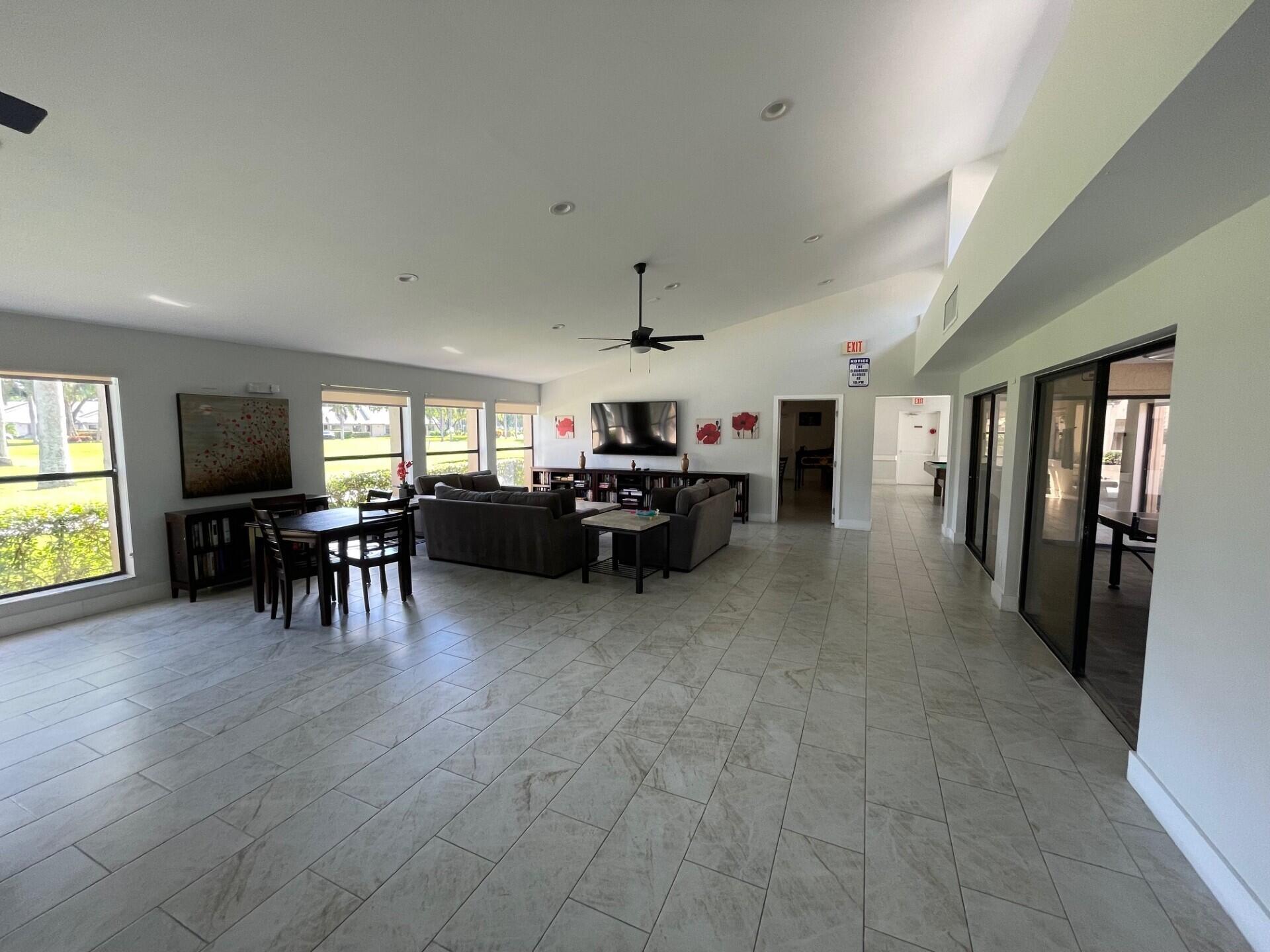 8471 Boca Glades Boulevard East Boca Raton, FL 33434 - Photo 22 of 29 a living room with furniture and a flat screen tv