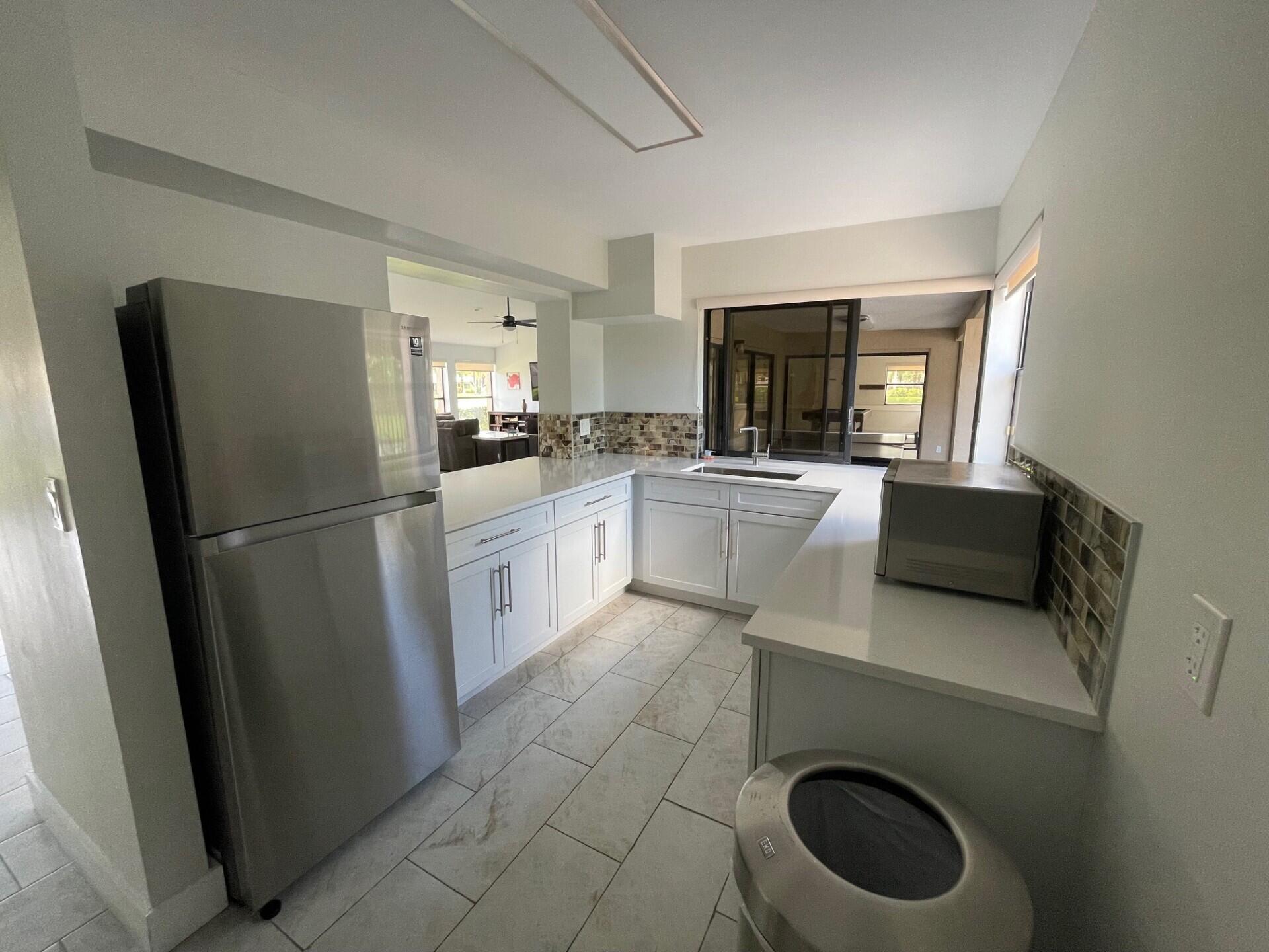 8471 Boca Glades Boulevard East Boca Raton, FL 33434 - Photo 26 of 29 a kitchen with a refrigerator sink and stove